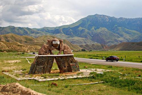 a statue of two elephants on the side of a road at Mikasa Guest House in Naryn