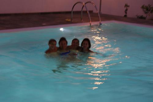 a group of four people in a swimming pool at BLOOM in Tropea