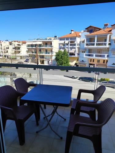 a blue table and chairs on a balcony with a view at Δροσιά in Nafplio
