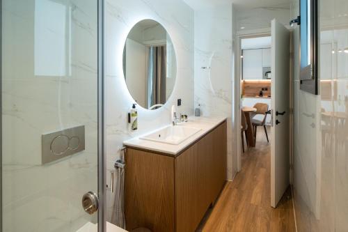 a bathroom with a sink and a mirror at Volos Inn Hotel in Volos