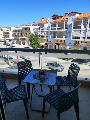 a table and chairs on a balcony with a view of a harbor at Δροσια 1 in Nafplio