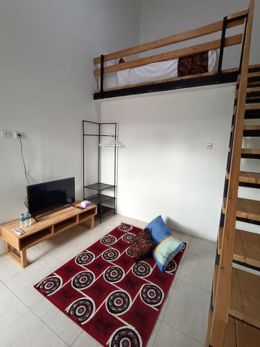 a living room with a couch and bunk beds at Jogja Amor Hotel in Demangan