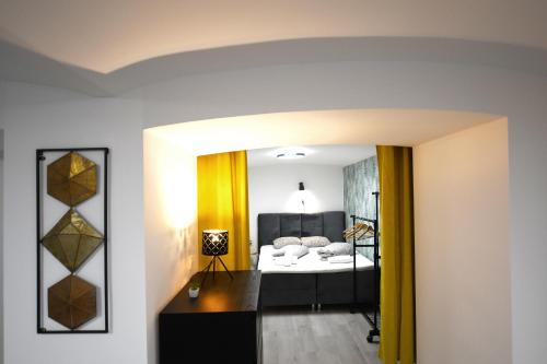 a bedroom with a bed and a mirror at The Maze Apartment in Ljubljana