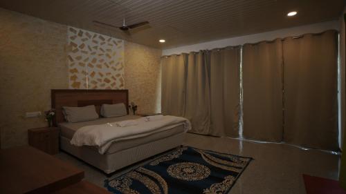 Een bed of bedden in een kamer bij Patnem Palm Garden