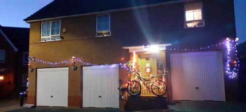 a house with christmas lights in front of it at Marina & Seagulls in East Cowes