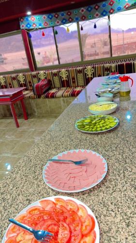 a table with plates of food on top of it at Shakria Bedouin Life Camp in Wadi Rum