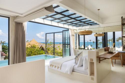a bedroom with a view of the ocean at White Goose Boutique Hotel in Canggu