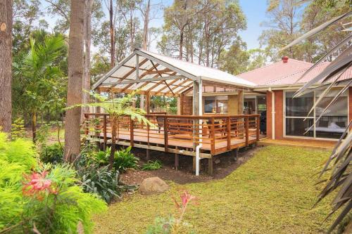 a house with a large deck in a yard at Riverslea Retreat in Margaret River Town
