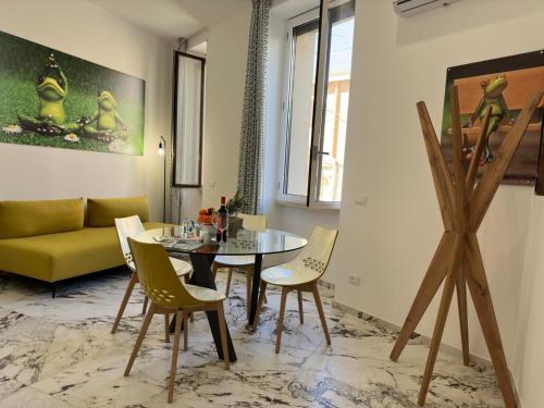 a living room with a table and a yellow couch at Hotel Exclusive in Agrigento