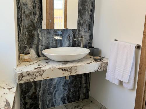 a bathroom with a white sink on a marble counter at Hotel Exclusive in Agrigento