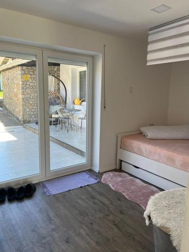 a bedroom with a bed and a patio with a table at U Vlcaku in Vřesovice
