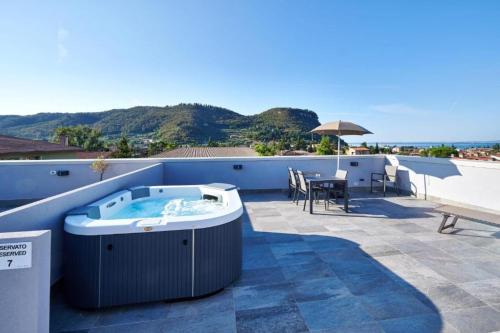 a hot tub on the roof of a house at Panoramic Apartment Rudi in Garda