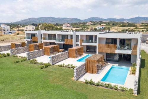 an aerial view of a house with a swimming pool at Aethrion Villas & Suites in Gennadi
