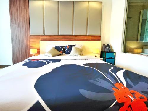 a bedroom with a large bed with a butterfly blanket at The Astra cozy living suite in Chiang Mai