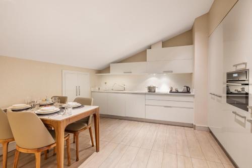 a kitchen and dining room with a table and chairs at Tzl Suites Hotel Nişantaşı in Istanbul