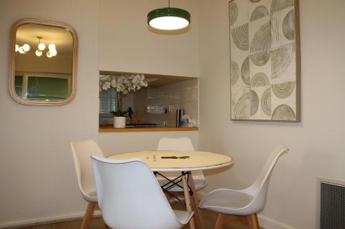 mesa y sillas en una habitación con espejo en Humble Abode near Ringwood, en Heathmont