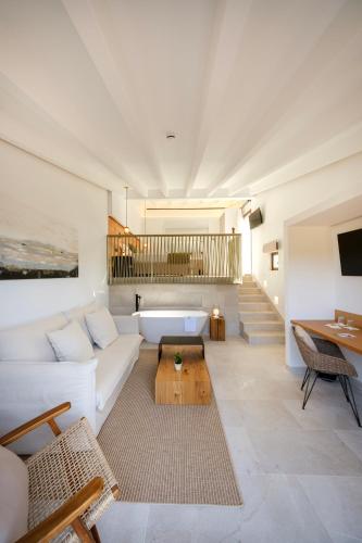 a living room with a white couch and a table at Fincahotel Treurer - Olive Grove & Grand House - Adults Only in Algaida