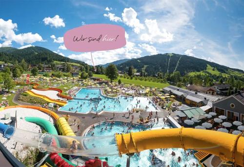 a view of a water park with a water slide at Mariengut - Natur Aparthotel Kramer in Wagrain