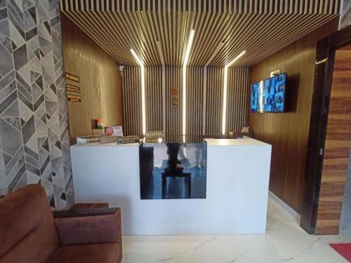 a lobby with a couch and a table in a room at Hotel Park View Near Sea Beach in Puri