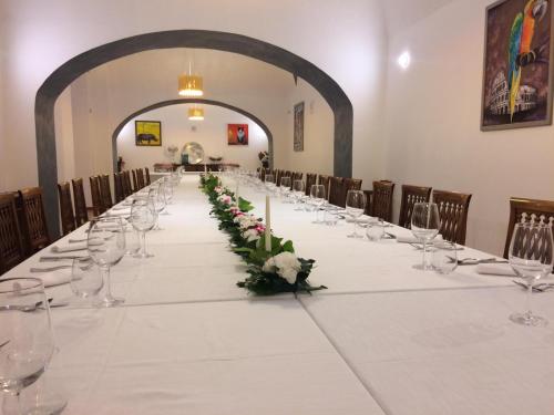 a long table with wine glasses and flowers on it at VillaGrancassa Hotel Relais in San Donato Val di Comino