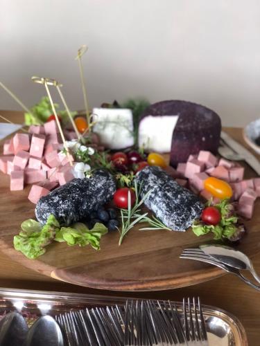 a plate of food with vegetables and meat on a table at VillaGrancassa Hotel Relais in San Donato Val di Comino