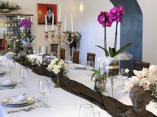 a table with a white table cloth and flowers on it at VillaGrancassa Hotel Relais in San Donato Val di Comino