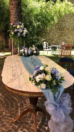 a table with a bunch of flowers on it at VillaGrancassa Hotel Relais in San Donato Val di Comino