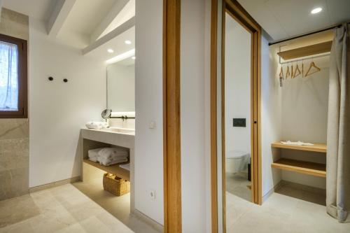 a bathroom with a sink and a mirror at Fincahotel Treurer - Olive Grove & Grand House - Adults Only in Algaida