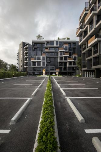 an empty parking lot with tall apartment buildings at Laguna SkyPark new brand apartments in Phuket Town