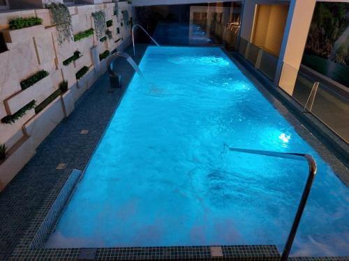 a large swimming pool with blue water in a building at Aldea Soma in Carnota