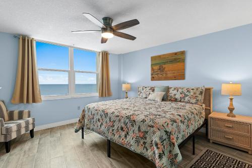a bedroom with a bed and a ceiling fan at Coronado Towers 703 in New Smyrna Beach