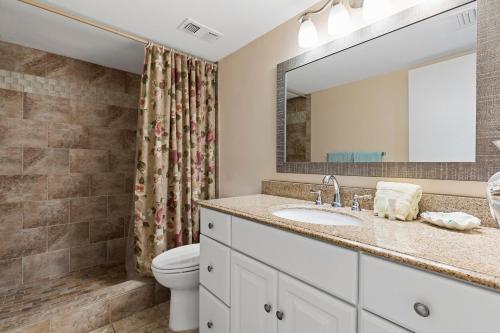 a bathroom with a sink and a toilet at Coronado Towers 703 in New Smyrna Beach