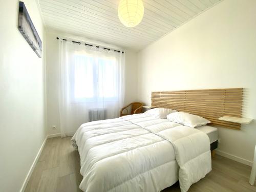 A bed or beds in a room at Maison renovee avec gout 700m de la plage