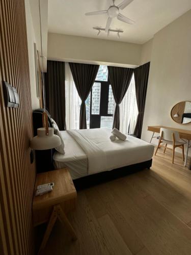 a bedroom with a bed and a large window at STAR RESIDENCE KLCC in Kuala Lumpur