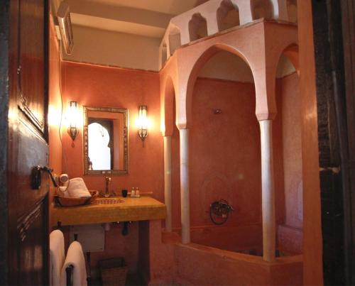 a bathroom with a sink and a shower and a mirror at Riad Palmier in Marrakech