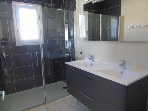 a bathroom with a sink and a shower at La Garenne in Saint-Jean-de-Monts