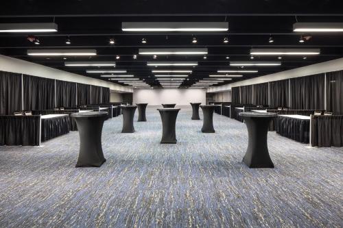 a large room with rows of tables and stools at The Westin Galleria Houston in Houston