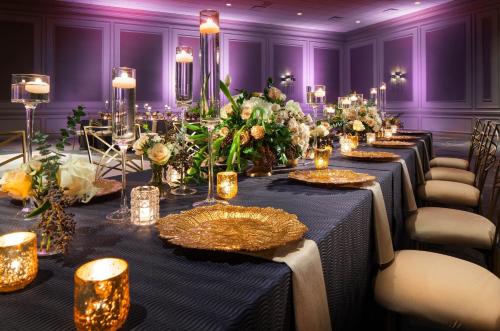 a row of tables in a room with purple walls at The Westin Galleria Houston in Houston