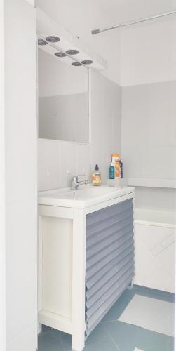 a white bathroom with a sink and a mirror at Ostoja Metro Bródno Warszawa in Warsaw