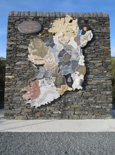 a stone wall with a map on it at John Eoinìn's Bar and accommodation in Glencolumbkille