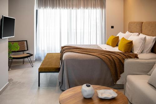 a hotel room with a large bed and a couch at Theta Boutique Hotel in Chania