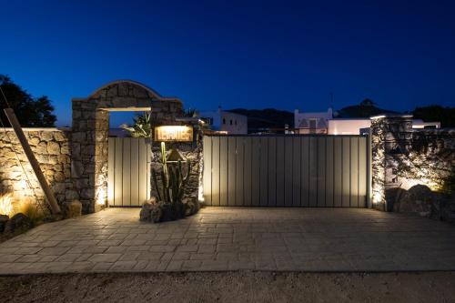 a gate to a building with lights on it at night at Levantes House Mykonos in Ano Mera