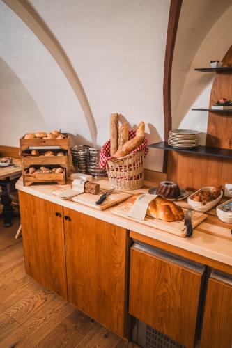 a kitchen with a counter with bread and other foods at Altstadt Hotel Stadtkrug in Salzburg