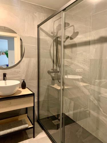 a bathroom with a glass shower and a sink at Cosy apartment in Almuñecar in Almuñécar