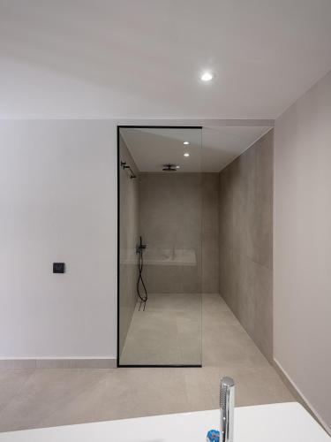 a bathroom with a shower and a glass door at Theta Boutique Hotel in Chania