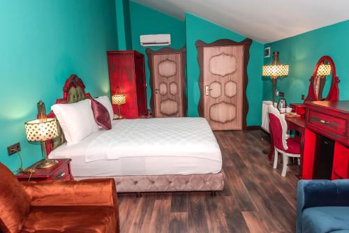 a bedroom with a bed and a desk and a couch at TOK EPİK HOTEL in Bursa