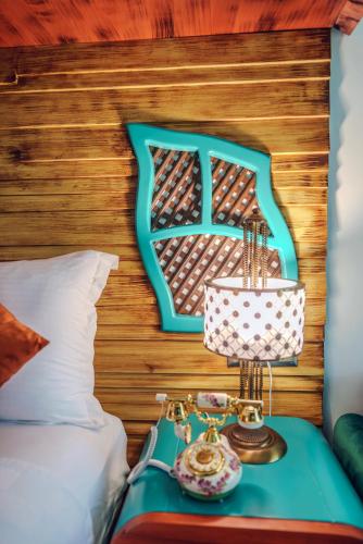 a bedroom with a bed and a table with a lamp at TOK EPİK HOTEL in Bursa