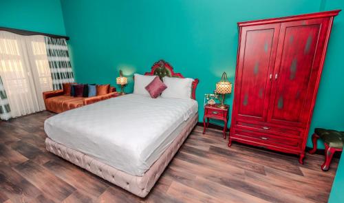 a bedroom with a large bed and a red dresser at TOK EPİK HOTEL in Bursa