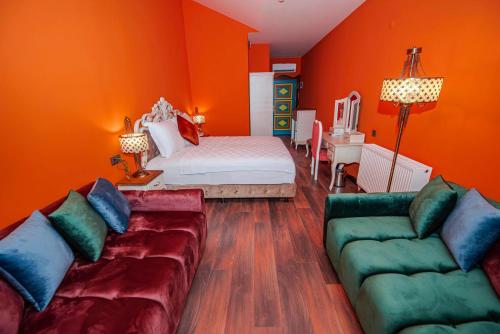 a living room with a bed and a couch at TOK EPİK HOTEL in Bursa