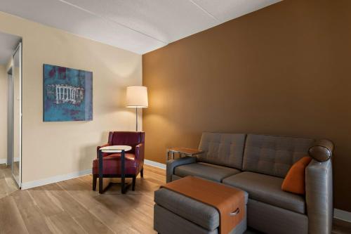 a living room with a couch and a table at Ramada by Wyndham Harrisburg/Hershey Area in Harrisburg